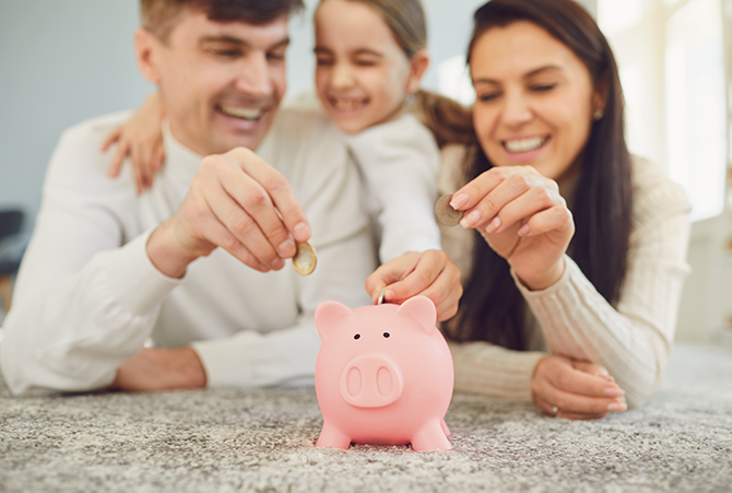 Happy Family Saving with Piggy Bank