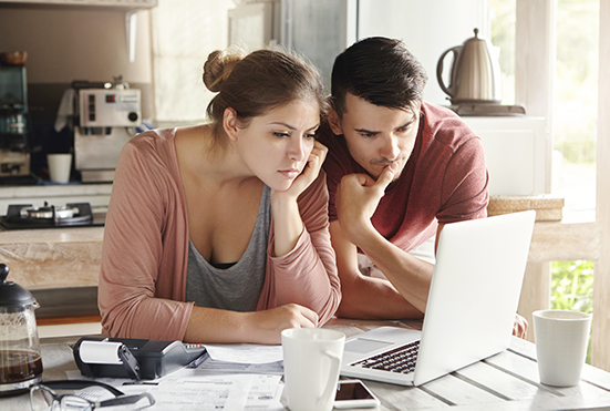 Couple navigating online loan options