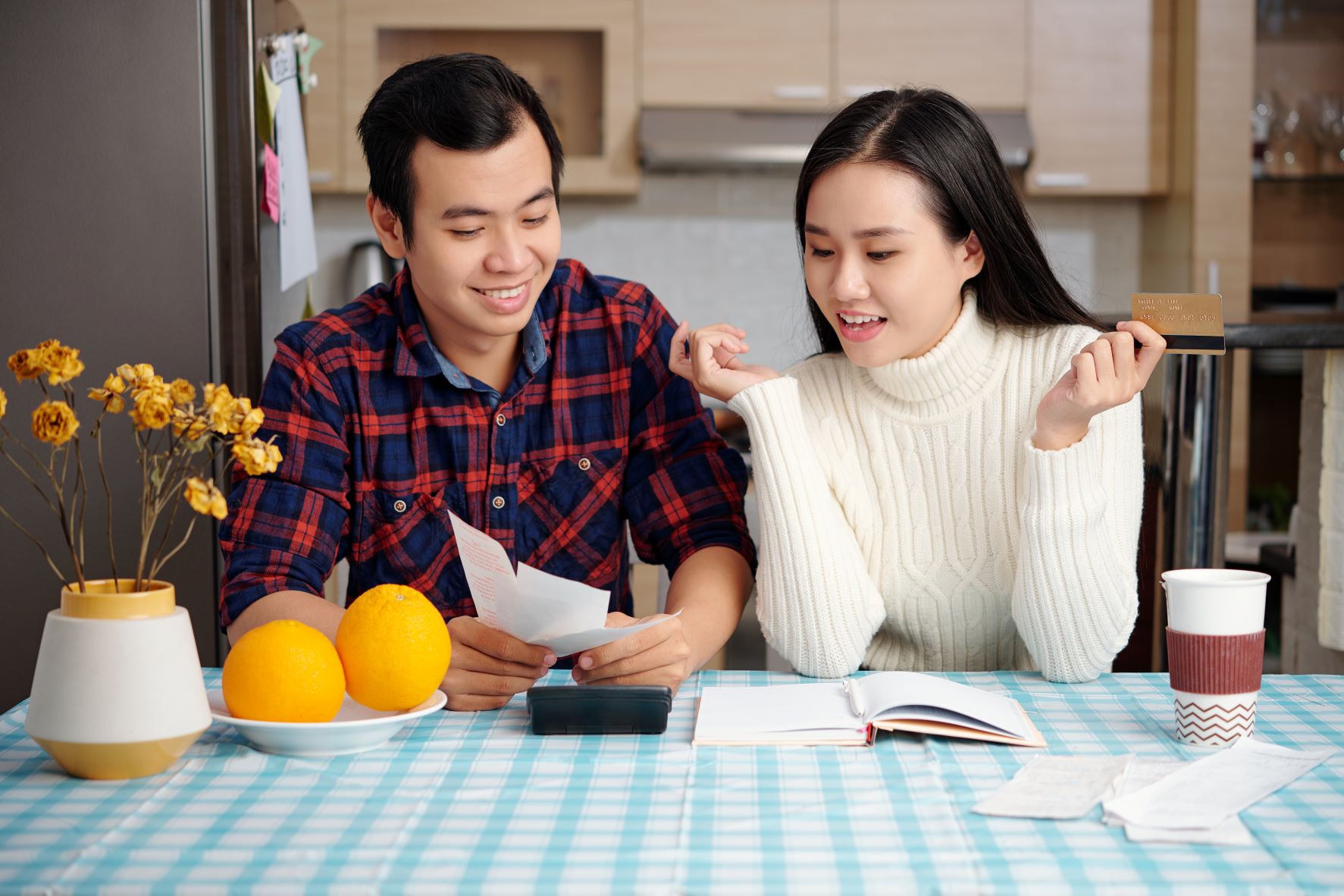 asian couple budgeting at home